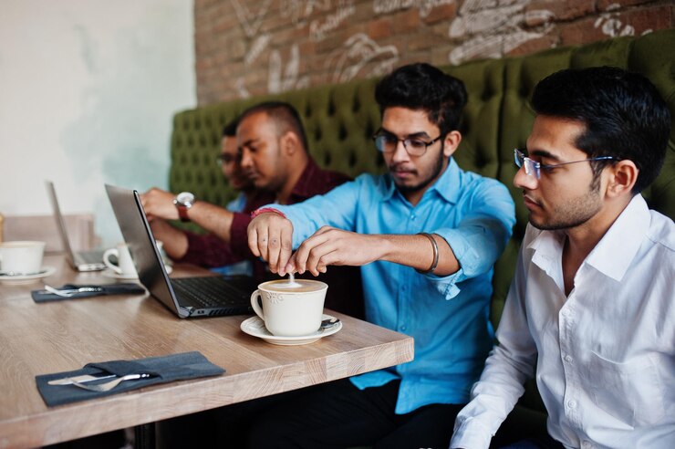 Group Four South Asian Men S Posed Business Meeting Cafe Indians Work With Laptops Together Using Various Gadgets Having Conversation Drink Coffee 627829 5235